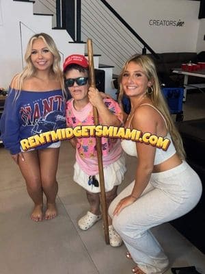 Little person entertainer in a novelty costume posing with guests at a Miami event
