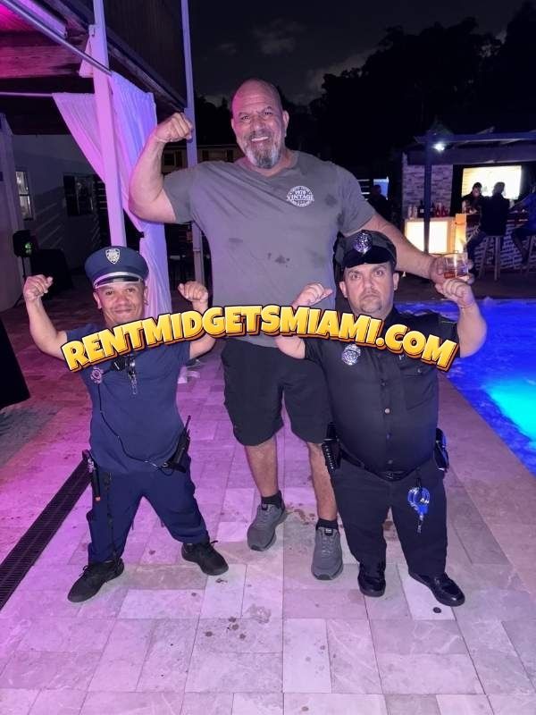 Two little person police officer entertainers posing with guests at a pool party in Miami